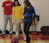 Seniors Justin Bradshaw and Haris Voksic watch as sophomore Jessica Raider participates in a game of indoor kickball. Photo by Matt Frischer.