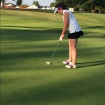 Senior Katie Karraker concentrates while on the putting green. Karraker enjoyed being a leader on the team this year. 