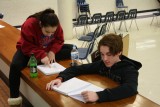 Senior Olivia Dudenhoffer looks over her lines next to senior Andrew Evans during last years production fo "The Adams Family." Dudenhoffer, who has had exceptional theatre experience throughout high school, will be majoring in Bachelor of Fine Arts in acting next year.